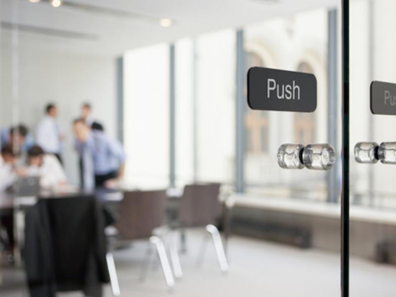 Office meeting behind glass doors
